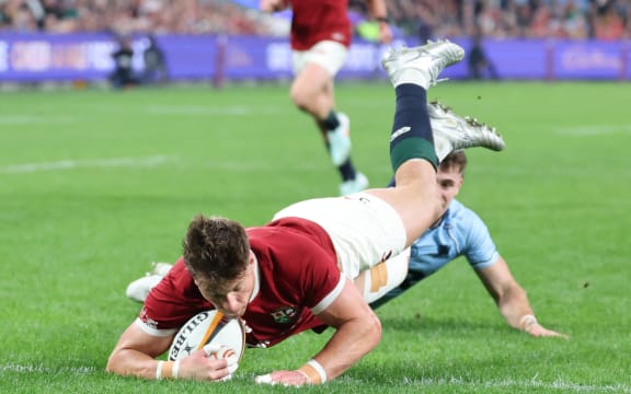 British and Irish Lions' Huw Jones dives to score a try during the rugby match between the British & Irish Lions and the NSW Waratahs.