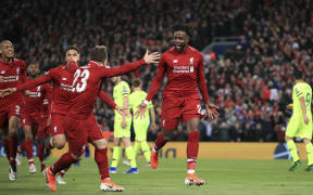 Liverpool's Divock Origi, center, celebrates scoring his side's fourth goal during the Champions League Semi Final between Liverpool and Barcelona at Anfield