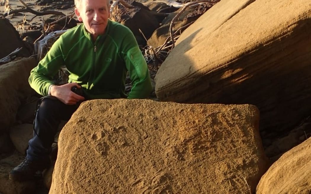 Geoscience communicator Julian Thomson with some of the moa footprints he and Dr Bruce Hayward discovered at Kaipara's South Head.