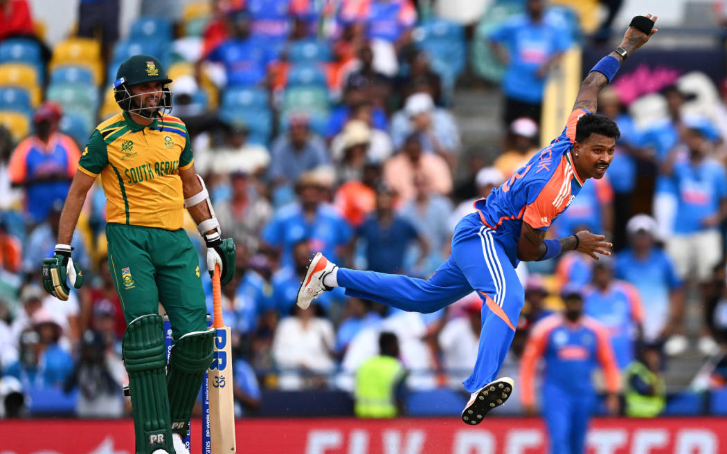 India's Hardik Pandya (R) bowls during the ICC men's Twenty20 World Cup 2024 final cricket match between India and South Africa at Kensington Oval in Bridgetown, Barbados, on June 29, 2024. (Photo by Chandan Khanna / AFP)