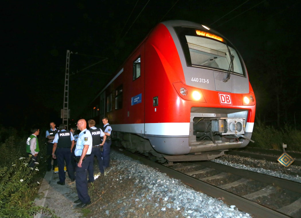Police officers stand by a regional train in Wuerzburg in southern Germany on July 18, 2016