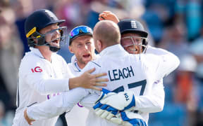 Jack Leach celebrates with teammates.