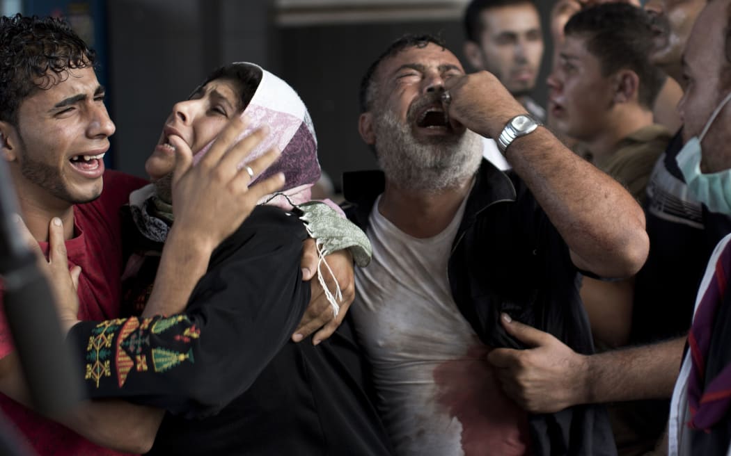 Palestinian mourners cry at Gaza City's al-Shifa hospital after an explosion killed children in a playground in late July.