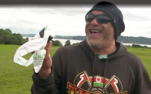 Man holding plastic bag - Dog owners adapt as some plastic poo bags phased out