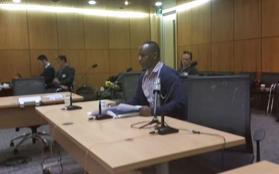 A refugee speaking in support of increasing the quota at a hearing yesterday.
