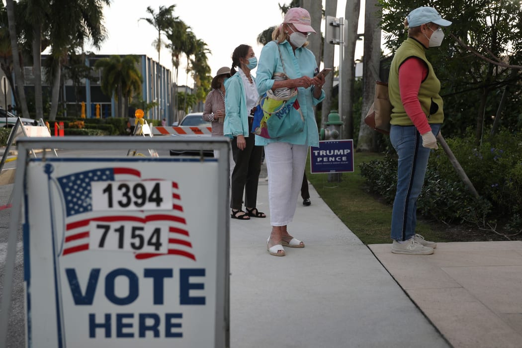 People stand in line to vote at the Morton and Barbara Mandel Recreation Center on November 03, 2020 in Palm Beach, Florida.