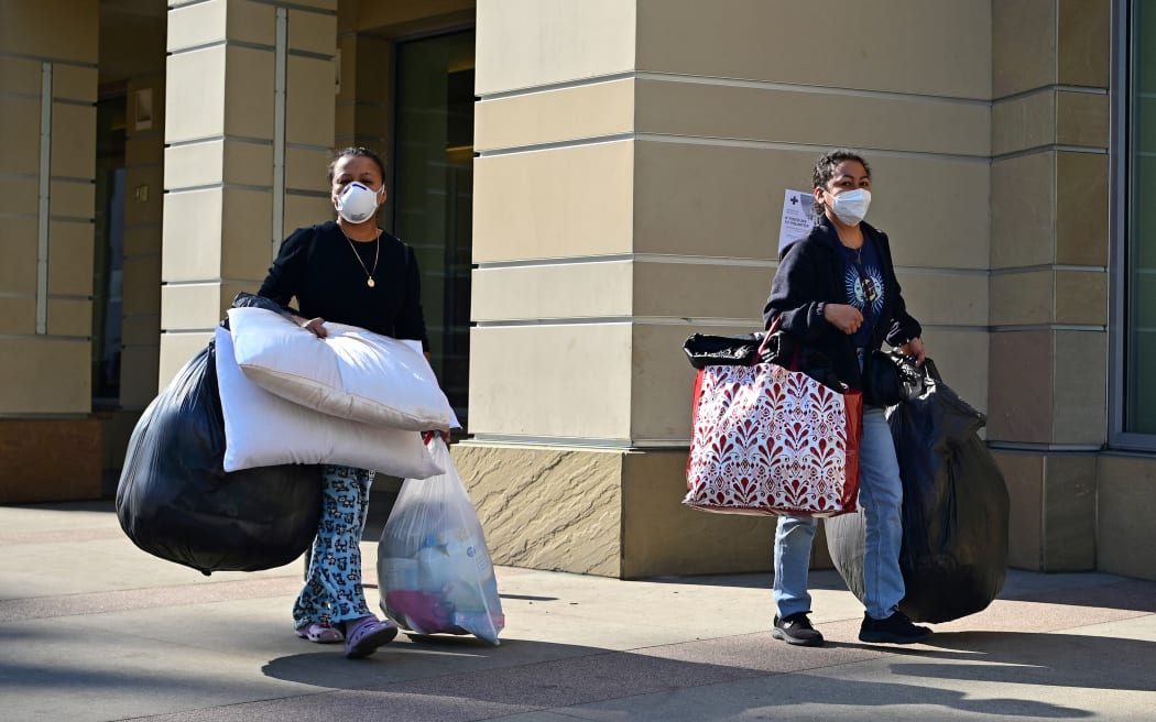 People arrive at an evacuation center in the Pasadena Convention Center in Pasadena, California, as they flee wildfires in the Los Angeles area on January 10, 2025. Massive wildfires that engulfed whole neighborhoods and displaced thousands in Los Angeles have killed at least 10 people, authorities said, as California's National Guard soldiers readied to hit the streets to help quell disorder.
News of the growing toll, announced late Thursday January 9 by the Los Angeles County Medical Examiner, came as swaths of the United States' second-largest city lay in ruins. (Photo by Agustin PAULLIER / AFP)