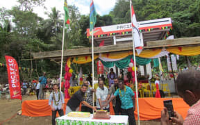Charlot Salwai cuts a cake to open the Pentecost fuel depot.