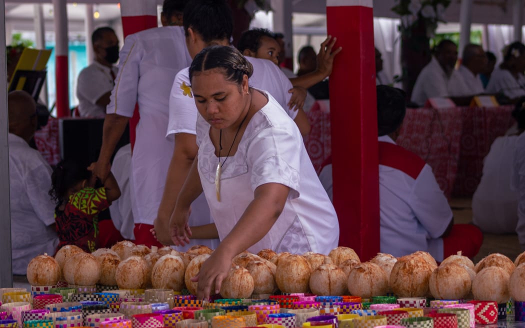 Coconuts being prepared to be passed out to everyone to toast to the new Ulu.