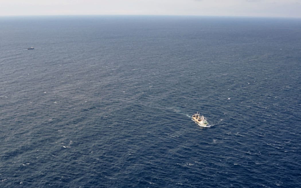 This handout picture taken and released by Russia's Emergency Ministry on April 2, 2015 shows ships carrying out a search operation in the Sea of Okhotsk where the trawler Dalny Vostok has sunk. At least 54 dead in trawler sinking off Russia'a Far East.