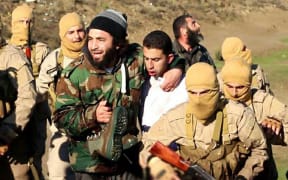IS posted photos showing the captured Jordanian pilot.