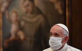 Pope Francis wears a protective face mask ahead of an inter-religious prayer service.