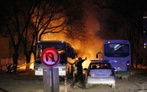 Firefighters try to extinguish flames after the attack.