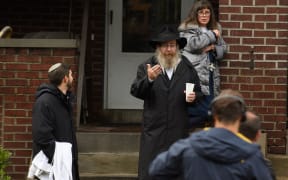 Residents talk to the media near the site of a mass shooting at the Tree of Life Synagogue in the Squirrel Hill neighborhood on October 27, 2018 in Pittsburgh, Pennsylvania.