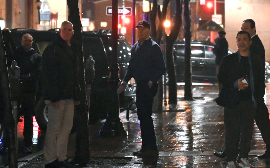 US President Joe Biden (C) looks on after a car hit an SUV in the motorcade as he left his campaign headquarters in Wilmington, Delaware on December 17, 2023. (Photo by ANDREW CABALLERO-REYNOLDS / AFP)