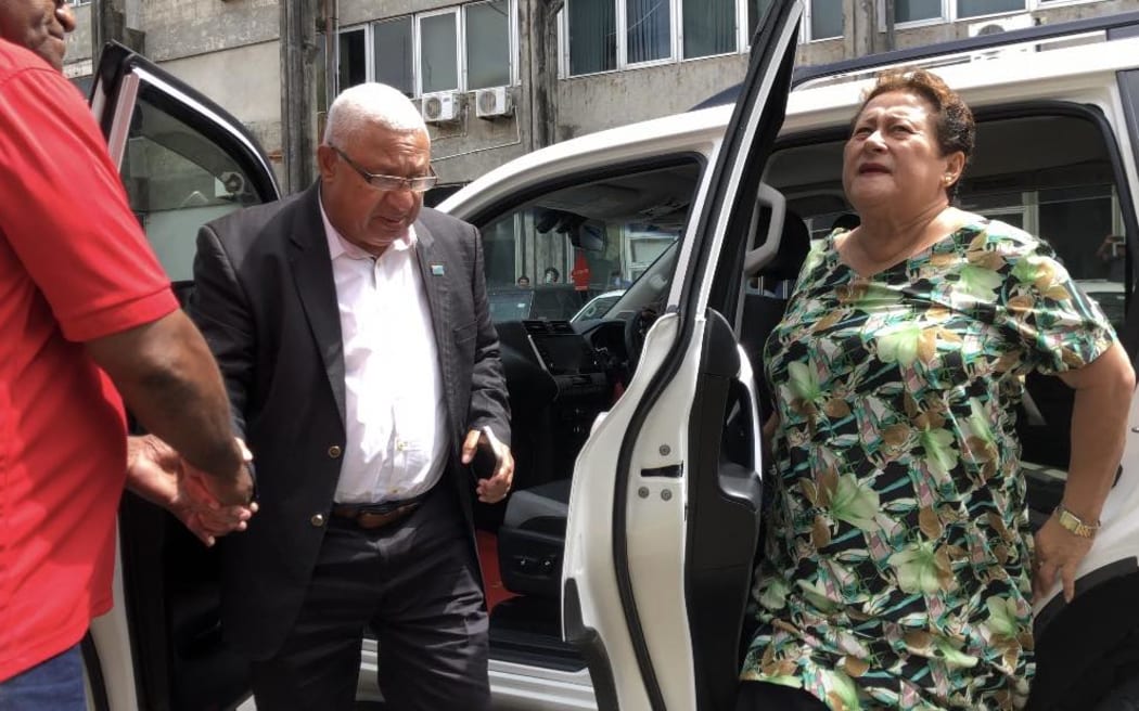 Bainimarama, middle, arrives to court with his wife, Mary, right, for the sentencing.