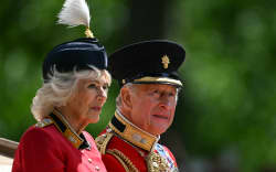 Britain’s King Charles III and Britain’s Queen Camilla make their way back to Buckingham Palace from Horse Guards Parade during the King’s Birthday  Parade “Trooping the Colour” in London on June 13, 2026. (Photo by JUSTIN TALLIS / AFP)