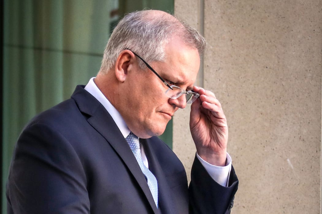 This file photo taken on March 22, 2020 shows Australia's Prime Minister Scott Morrison reacting during a press conference at Australia's Parliament House in Canberra.