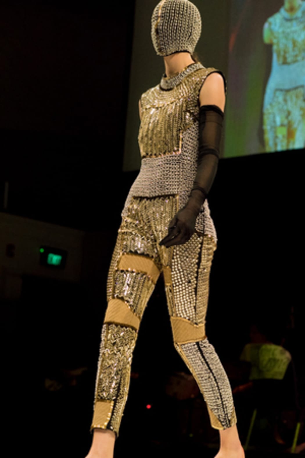 Yousef Akbar's mask and full beaded garments make a striking impact.