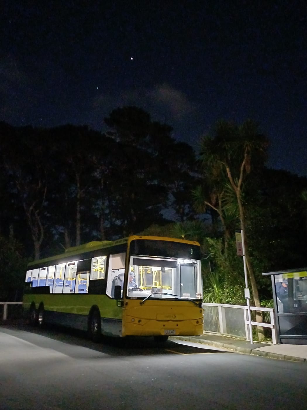 Metlink bus and bus stop after dark.