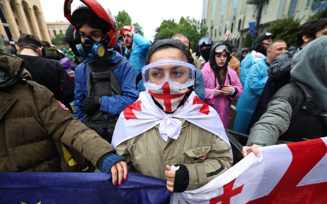 Georgian protesters rally against the controversial "foreign influence" bill in Tbilisi on May 14, 2024. Georgia's parliament on May 14, 2024 adopted a controversial "foreign influence" law that has sparked weeks of mass protests against the measure, denounced as mirroring Russian legislation used to silence dissent. The bill requires non-governmental organisations and media outlets that receive more than 20 percent of their funding from abroad to register as bodies "pursuing the interests of a foreign power." (Photo by Giorgi ARJEVANIDZE / AFP)