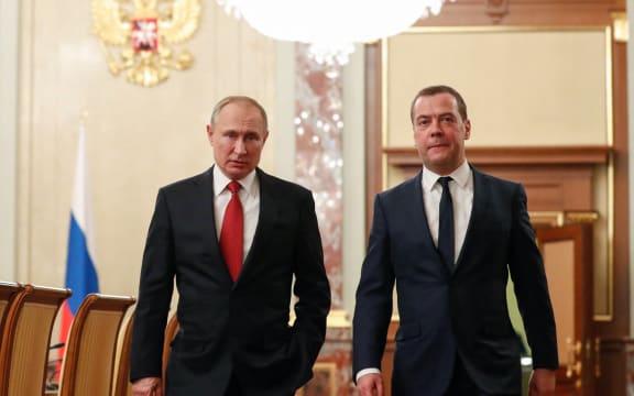 Russian President Vladimir Putin and Russia's Security Council deputy chairman Dmitry Medvedev walk before a meeting with members of the government in Moscow on January 15, 2020.
