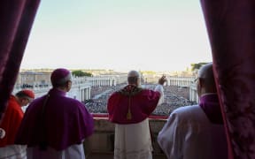 This photo taken and handout on May 7, 2025 by The Vatican Media shows Newly elected Pope Leo XIV, Robert Prevost addressing the crowd from the main central loggia balcony of the St Peter's Basilica for the first time, after the cardinals ended the conclave, in The Vatican. (Photo by Handout / VATICAN MEDIA / AFP) / RESTRICTED TO EDITORIAL USE - MANDATORY CREDIT "AFP PHOTO / VATICAN MEDIA" - NO MARKETING - NO ADVERTISING CAMPAIGNS - DISTRIBUTED AS A SERVICE TO CLIENTS