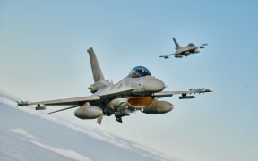 F 16 fighter jets takes part in the NATO Air Shielding exercise near the air base in Lask, central Poland on October 12, 2022. (Photo by RADOSLAW JOZWIAK / AFP)