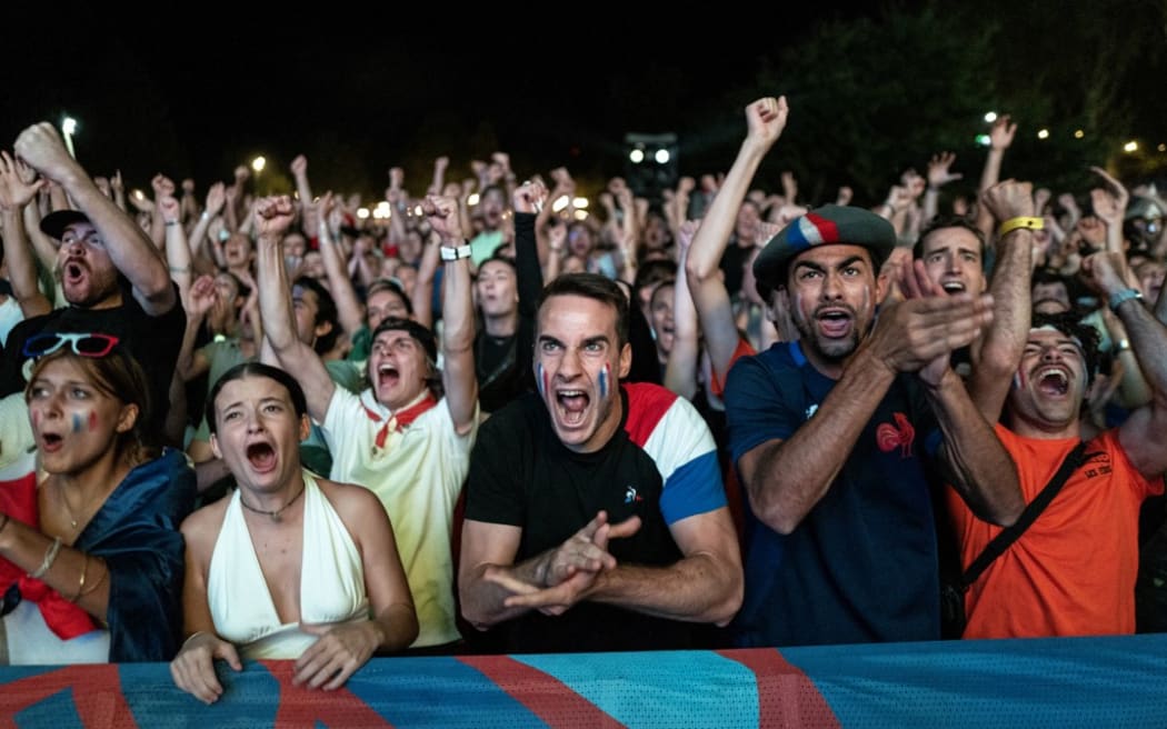 France supporters react as they watch the opening match of the 2023 Rugby World Cup between France and New Zealand at a fan zone in Toulouse, southwestern France, on September 8, 2023. (Photo by Charly TRIBALLEAU / AFP)