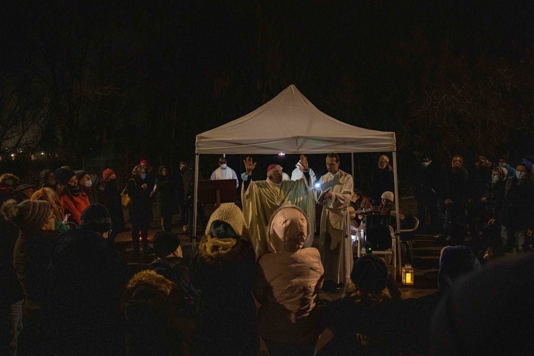 Bishop of Arras Olivier Leborgne (centre) leads a Christmas mass for immigrants near their camps in Calais, France.