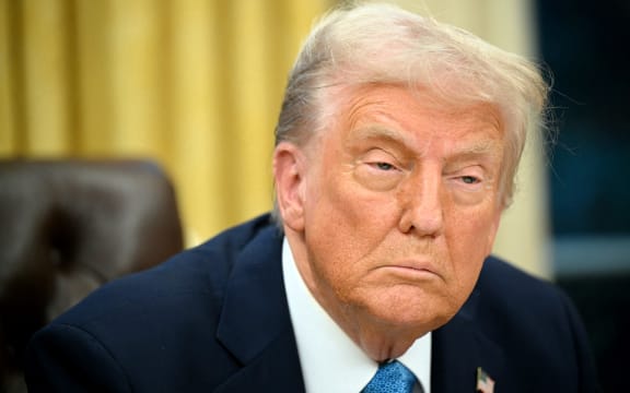 (FILES) US President Donald Trump speaks to the press after signing an executive order in the Oval Office of the White House in Washington, DC on January 31, 2025. Trump is imposing steep tariffs on major US trading partners Canada, Mexico and China, with a lower rate on Canadian energy imports, said the White House on February 1, 2025. Washington will impose a 25 percent levy on imports from Canada and Mexico, with a 10 percent rate on Canadian energy resources, until both work with the United States on drug trafficking and immigration. Goods from China, said the White House, would face 10 percent tariffs. (Photo by Mandel NGAN / AFP)