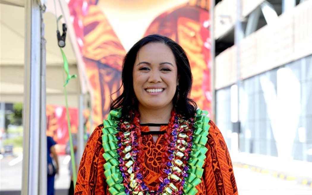 Vasa Fia Collins in front her Mural of her late husband Fa'anānā Efeso Collins