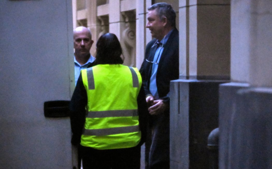 Former Jetstar pilot Greg Lynn (R) is led from court in Melbourne on June 25, 2024 after he was found guilty by a jury of murdering retiree Carol Clay at a Victorian campsite in March 2020, but was found not guilty of murdering her fellow camper Russell Hill. Lynn was convicted on June 25 of killing Clay during the altercation with the two elderly campers at the Wonnangatta Valley area of Victoria. Although pleaded not guilty, Lynn admitted to destroying evidence by burning the pair's remains. (Photo by William WEST / AFP)