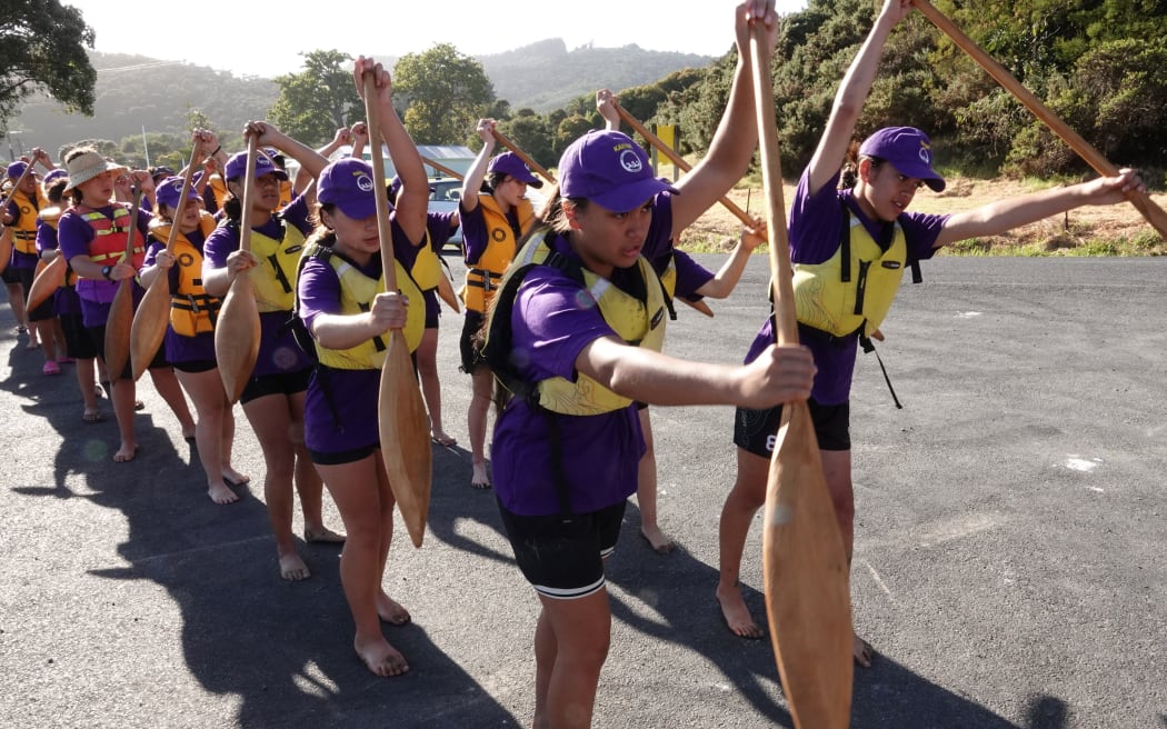 Young kaihoe (paddlers) from the waka Kaitoki practise paddle drills at Horeke.