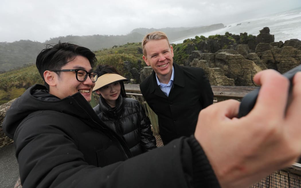 Chris Hipkins with tourists at Punakaiki rocks.