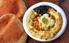Hummus with olive oil, herbs, pitta bread and spices.
