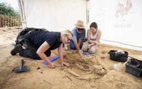 Forensic Anthropologist Gaille MacKinnnon excavating the bones.