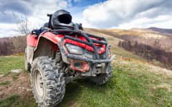 ATV on mountains landscape on a sunny day