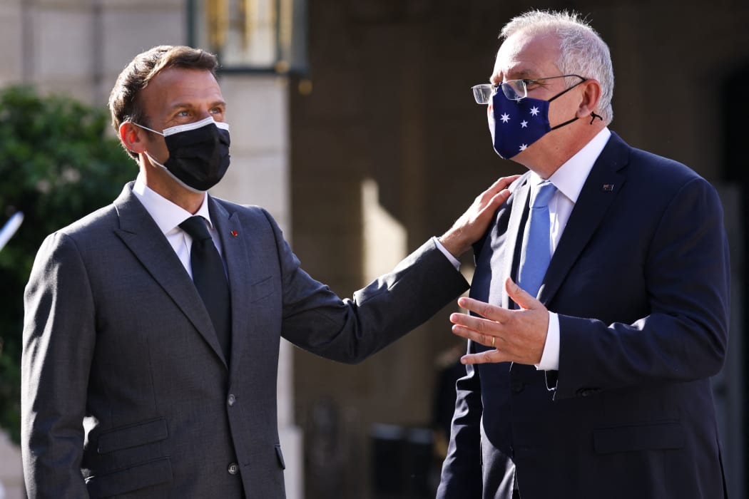 French President Emmanuel Macron greets Australian Prime Minister Scott Morrison at the Elysee Palace in Paris on 15 June, 2021.