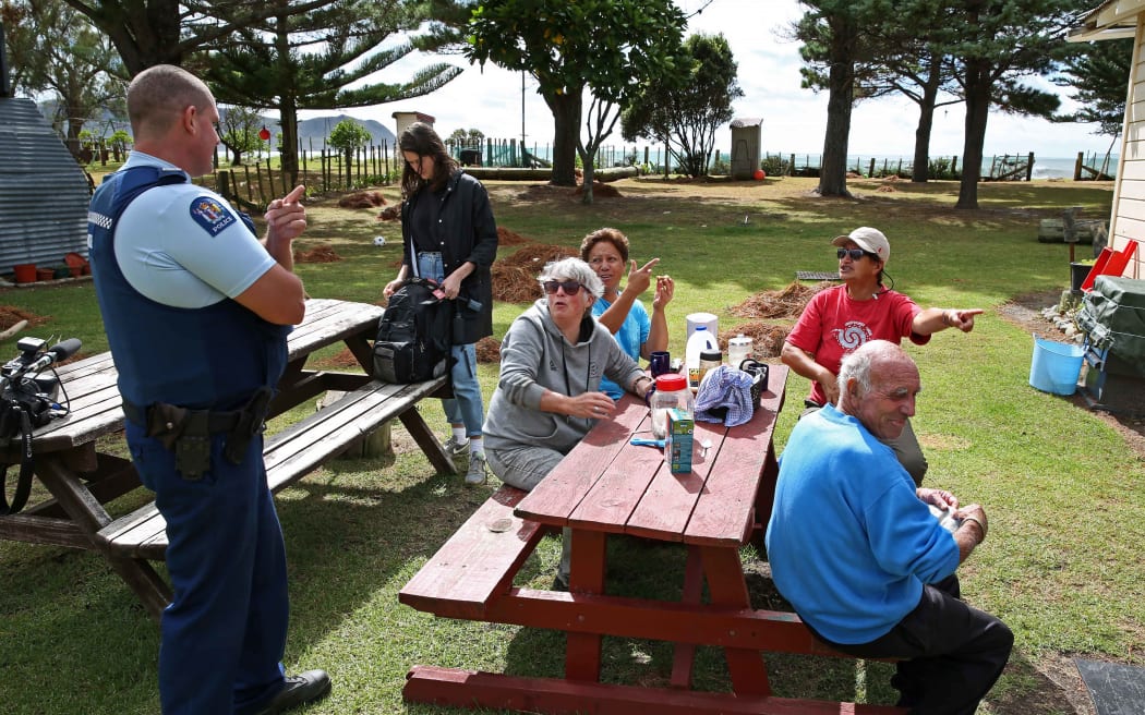 Anaura residents gathering around at Kahu Brown's house after cleaning up after the storm.