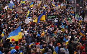 Demonstrators waving flags of Ukraine attend a demonstration in support of Ukraine, on Karl-Marx-Allee in Berlin, on February 24, 2023, the first anniversary of Russia's invasion of Ukraine. (Photo by Odd ANDERSEN / AFP)