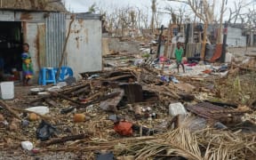 Little kids playing in the wreckage of their home on Mataso after the cyclone.