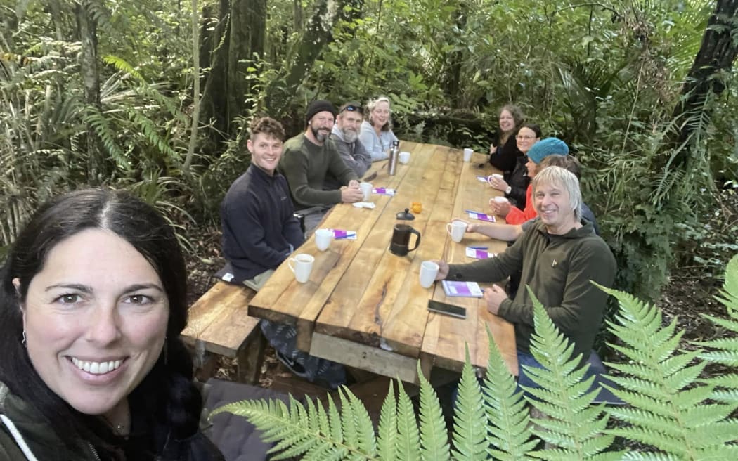 Kylie Rae (left) with a group settling in for a bush board meeting.