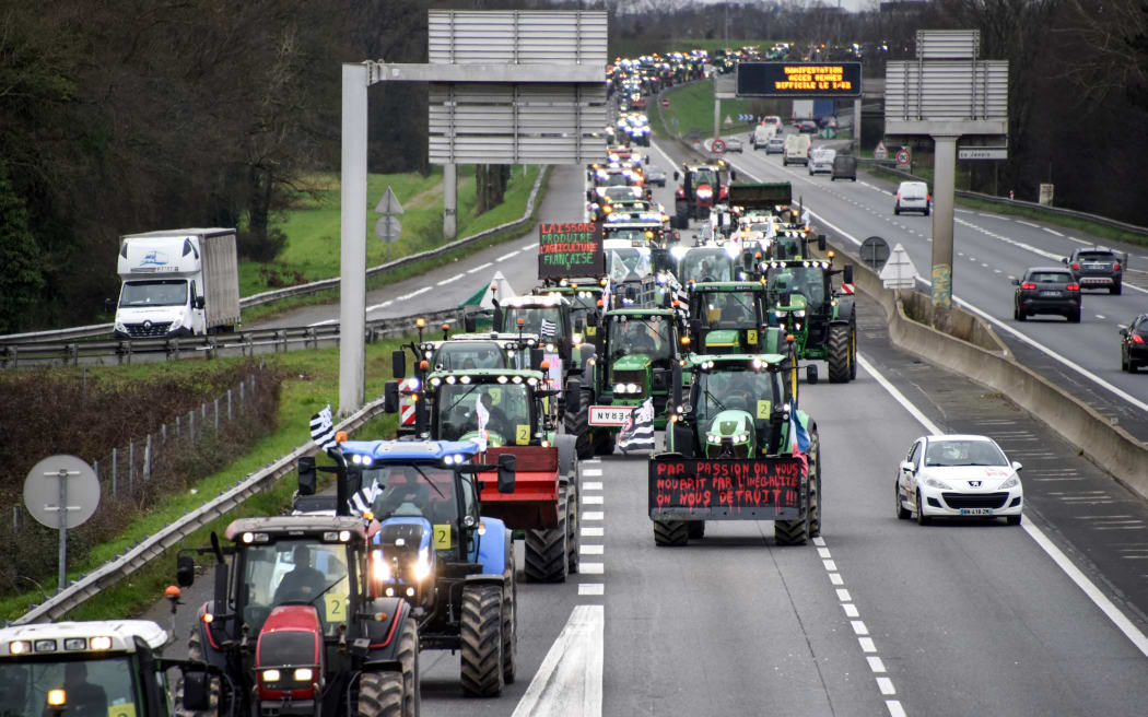 Farmers drive their tractors on the ring road of Rennes, western France, on February 1, 2024, as part of nationwide protests called by several farmers' unions over pay, tax and regulations. France's government offered a slew of new concessions on February 1, 2024, to farmers, hoping to calm anger behind tractor blockades of major roads nationwide as farmers have been out in force for more than a week in protests triggered by an agricultural fuel duty hike, complaining their pay is squeezed, taxes are too high and regulations too onerous. (Photo by Sebastien SALOM-GOMIS / AFP)