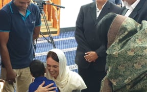 Ardern hugs the great grandson of Ashraf Ali Razak, who died in the mosque attack.