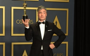 New Zealand director Taika Waititi poses in the press room with the Oscar for Best Adapted Screenplay for "Jojo Rabbit".