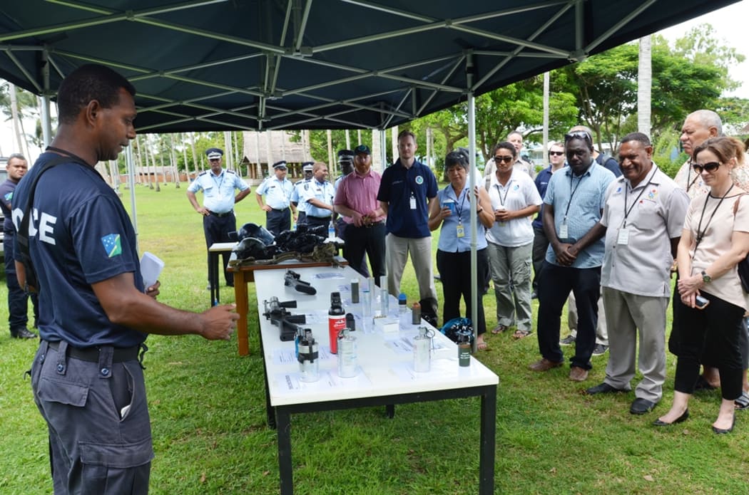 A RSIPF PRT officer shows the equipment used for crowd control
