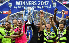 Bermudan Nahki Wells (far right) plays as a forward for the Huddersfield Town football team.