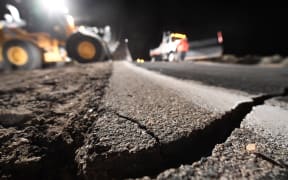 Highway workers repair a hole that opened in the road as a result of the July 5, 2019 earthquake, in Ridgecrest, California, about 150 miles (241km) north of Los Angeles,