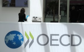 A participant stands at the OECD headquarters in Paris during the presentation of the Economic Outlook at the 2013 OECD Week on May 29, 2013